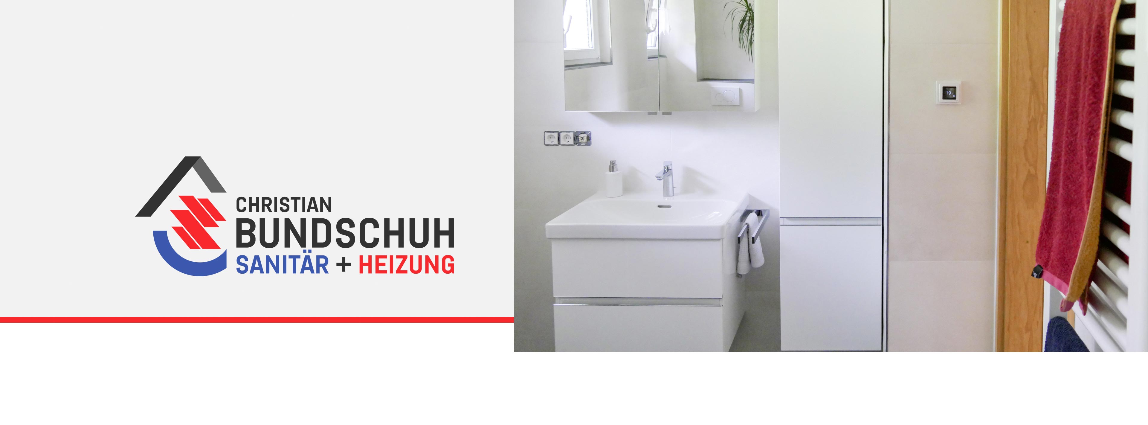 Eines unserer Bäder mit Waschtisch, Handtuchheizkörper und Badschränken